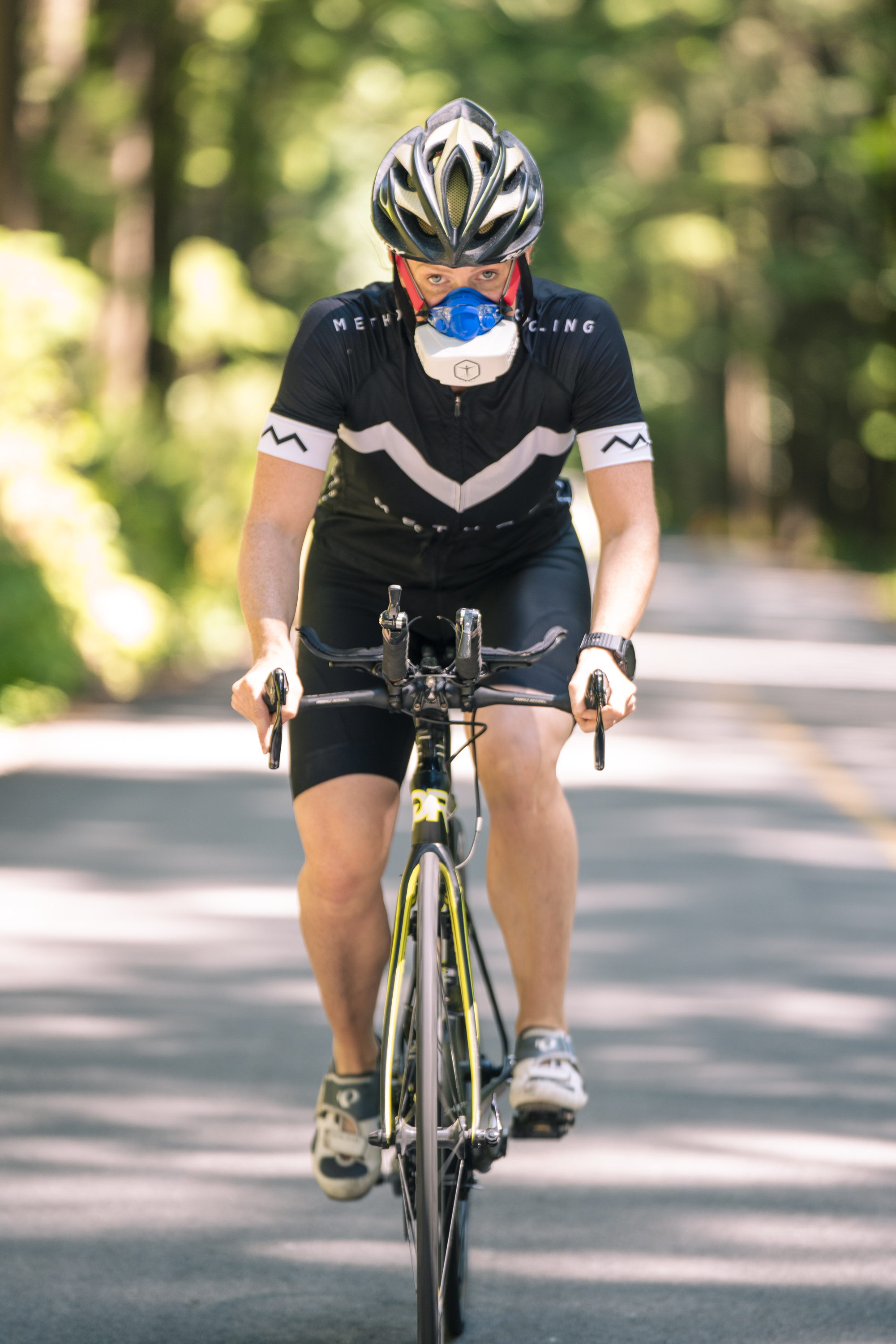 Cyclist riding outdoors wearing a VO2 Master analyzer mask